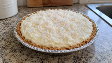 Whole chilled no-cook coconut pie in a graham cracker crust topped with shredded coconut