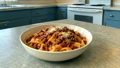 Bowl of tagliatelle coated with thick slow-simmered beef-and-pork Bolognese and freshly grated Parmesan